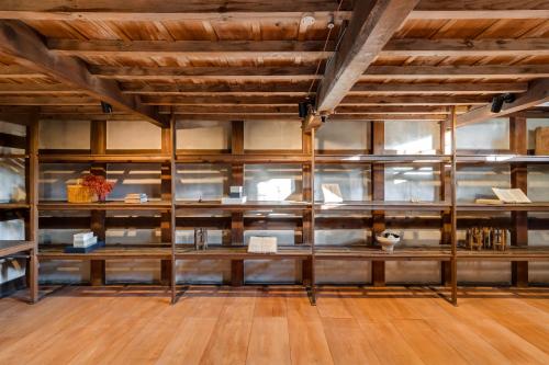 a large room with wooden ceilings and wooden floors at NIPPONIA Sawara Merchant Town Hotel in Katori