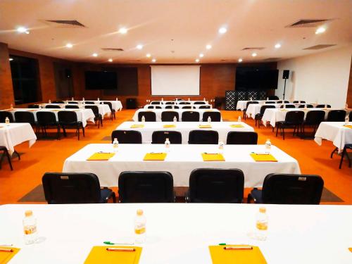 a large room with white tables and black chairs at Holiday Inn Mexico Santa Fe by IHG in Mexico City