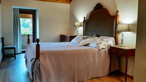 - une chambre avec un grand lit et une tête de lit en bois dans l'établissement 7 bedrooms villa with private pool enclosed garden and wifi at Povoa de Lanhoso, à Póvoa de Lanhoso