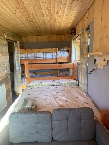 a bed in the middle of a room at Honeysuckle Straw Bale Cabin in Dallas