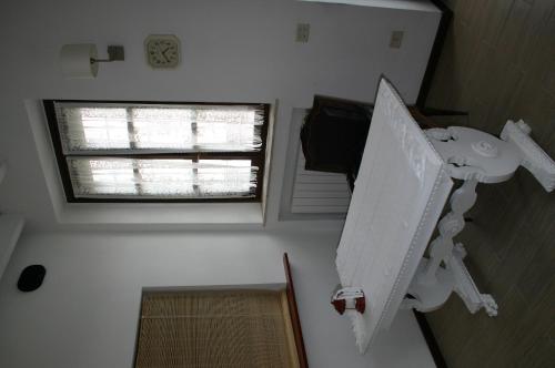 a small bathroom with a sink and a window at Dragonfly B&B in Certosa di Pavia