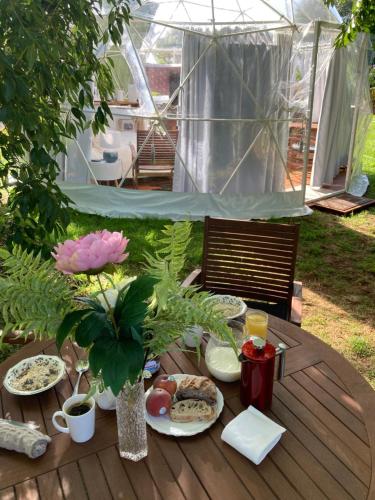 a wooden table with plates of food on it at English Cherry Tree Manor in Tamahere