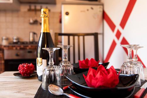 a bottle of champagne and glasses on a table at Relax a 4 salti dai navigli in Milan