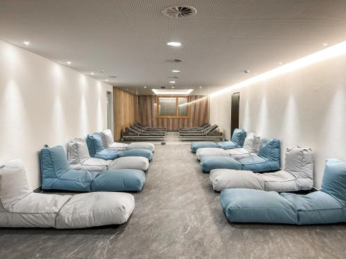 a waiting room with blue and white couches at Hotel-Gasthof Löwen in Feldkirch