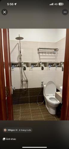 a bathroom with a toilet and a shower at Hotel Đại Dương in Thuan An
