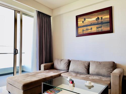 a living room with a couch and a coffee table at The Sea Luxury Nha Trang Apartment in Nha Trang