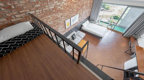 a room with a staircase and a brick wall at Lucid M in Seogwipo
