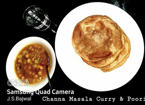 a plate of food with a bowl of soup and a sandwich at Bajwal Home-Stay & Guest-House in Sari
