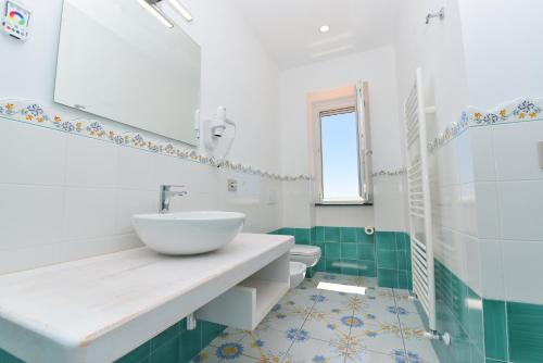 a bathroom with a sink and a toilet at LA CASA DEL CAPITANO furore amalfi coast in Furore