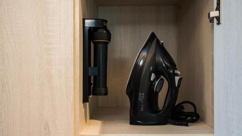a black hair dryer and a hair dryerventory at FOX Hotel Glenmarie Shah Alam in Shah Alam