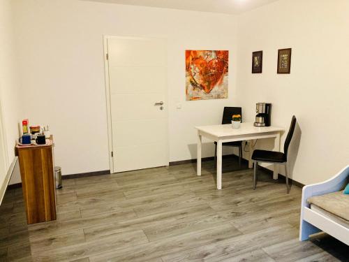 a room with a table and a white door at Sauna-Schmied in Weißenfels