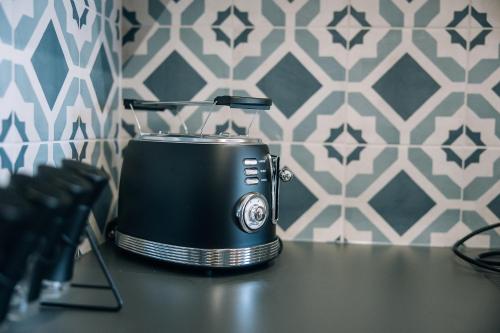 a black toaster sitting on top of a counter at Postcard Country Apartments in Spodnji Duplek