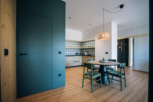 a kitchen and dining room with a table and chairs at Postcard Country Apartments in Spodnji Duplek