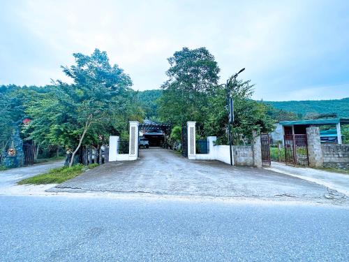 an empty road with a gate on the side at The Hill Villas in Phong Nha