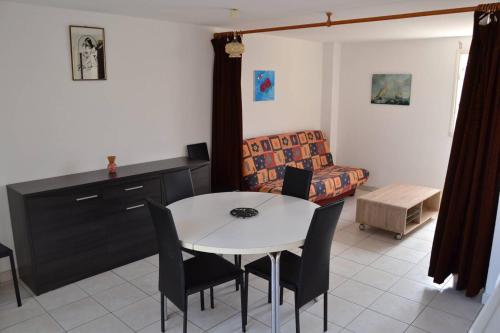 un salon avec une table, des chaises et un canapé dans l'établissement 013 Agathes 389, au Cap d'Agde