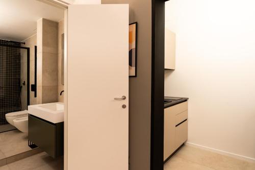 a bathroom with a toilet and a sink at Loft 404 by Wonderful Italy in Bari