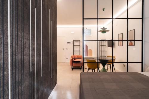 a bedroom with a table and a dining room at Loft 404 by Wonderful Italy in Bari