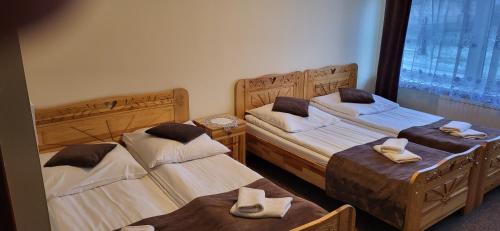 a room with two beds with towels on them at Willa Nad Białką in Białka Tatrzańska