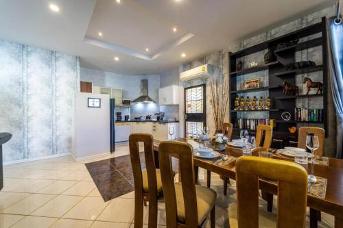 a kitchen and dining room with a table and chairs at 3 Bedroom Pool Villa Close to City Center! S102 in Hua Hin