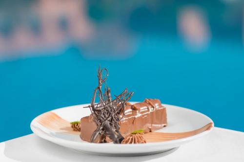 a piece of chocolate cake on a plate on a table at Aquafun By Grand Mogador Agdal in Marrakech