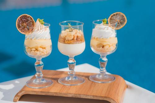 three desserts in glasses on a wooden tray at Aquafun By Grand Mogador Agdal in Marrakech