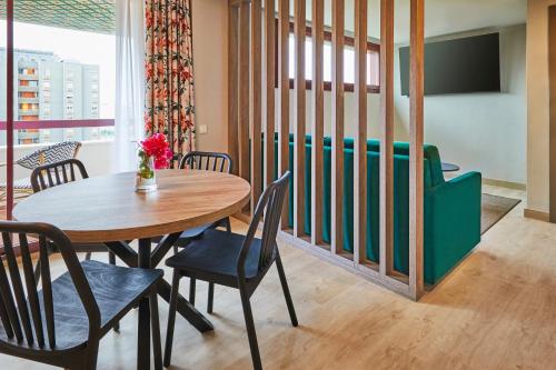 a dining room with a table and chairs at Hesperia Sevilla in Seville
