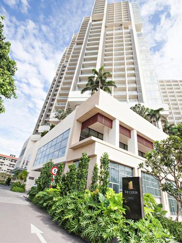 a large white building with trees and plants in front of it at The Sea Luxury Nha Trang Apartment in Nha Trang