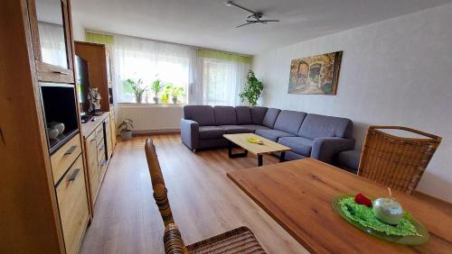 a living room with a couch and a table at Pension Haus Germania in Erfurt