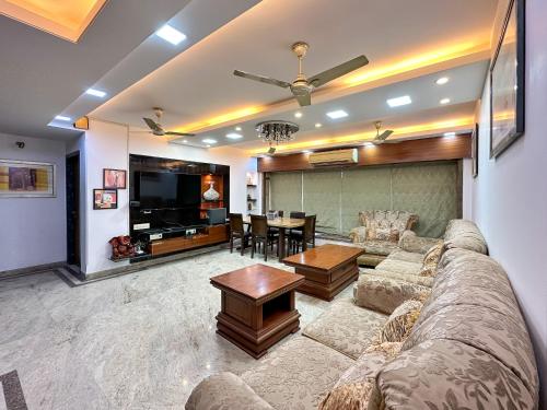 a living room with a couch and a table at Welcome Home Service Apartments - Andheri in Mumbai