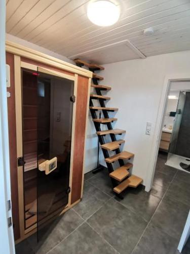 a room with a staircase in a house at Ferienhaus in der Rhön Sitzmann in Bischofsheim an der Rhön