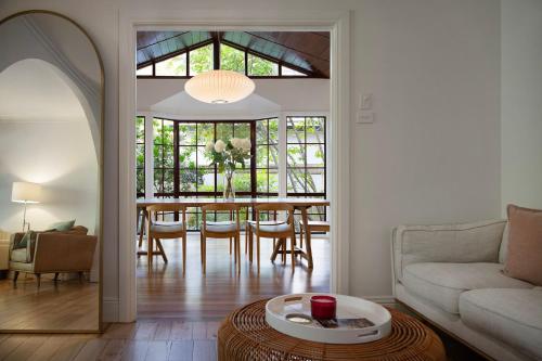 a living room with a table and a couch at Stanbridge House- perfect escape, modern comforts in Daylesford