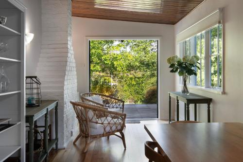 a dining room with a table and a large window at Stanbridge House- perfect escape, modern comforts in Daylesford