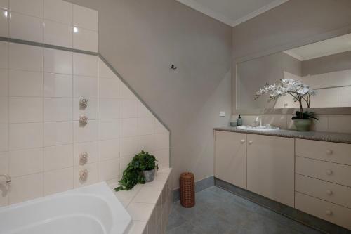 a bathroom with a tub and a sink at Stanbridge House- perfect escape, modern comforts in Daylesford