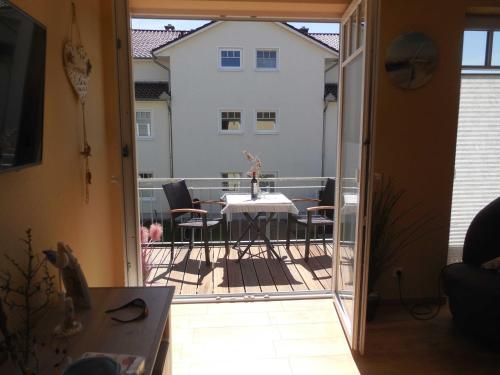 a view of a balcony with a table and chairs at Exkl App Bernstein, Kamin, Waschmaschine, 250 m zum Strand in Börgerende-Rethwisch