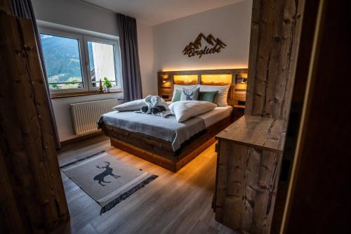 a bedroom with a bed and a window at Tiroler Alpblick Appartements in Ehrwald