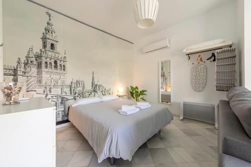 a bedroom with a bed with a drawing on the wall at Arco del Postigo in Seville