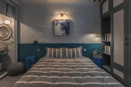 a bedroom with a bed with a blue wall at Súp Lơ House (Broccoli's House) in Da Lat