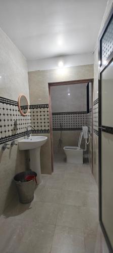 a bathroom with a sink and a tub and a toilet at Kulswami Cottage Alibag in Alibaug