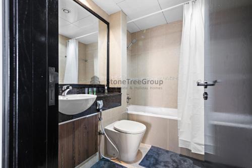 a bathroom with a toilet and a sink at StoneTree - New Studio in JLT in Dubai