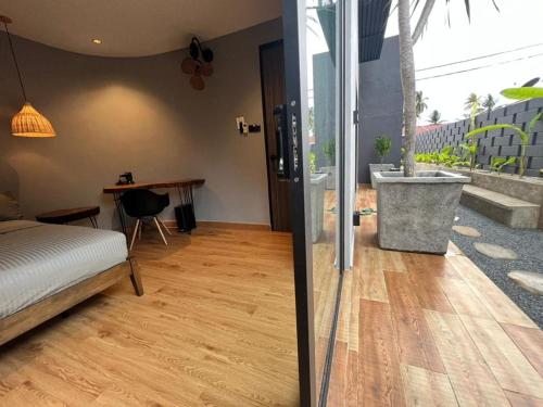 a bedroom with a bed and a desk and a sink at LA Villas Kuantan Private Pool,Near Beach,BBQ,Karaoke in Kuantan