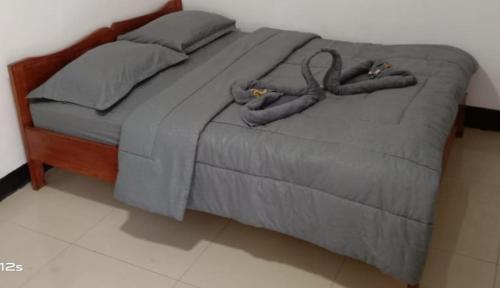 a bed with two ottomansacers at BHELENA GUEST HOUSE in Kelimutu