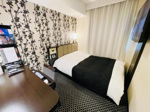 Un pat sau paturi într-o cameră la APA Hotel Akihabaraeki-Denkigaiguchi
