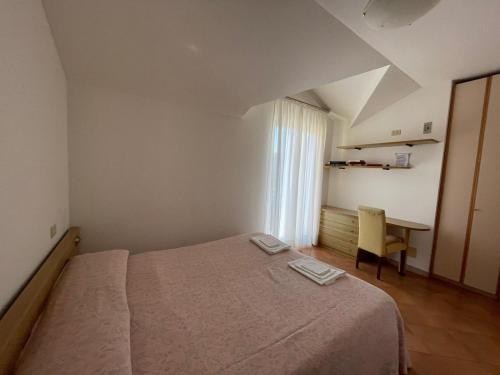 a small bedroom with a bed and a desk at Da Teresa in Bardineto