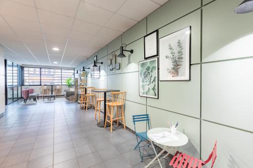 a dining room with tables and chairs in a building at Appart'City Classic Limoges in Limoges