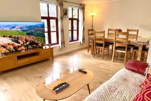 a living room with a couch and a table and a tv at Flat in Manchester, Ardwick in Manchester