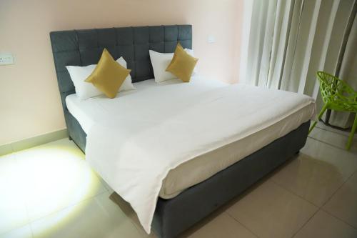 a bed with yellow pillows in a room at Pine Hideout in Kathua