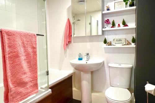 a bathroom with a sink and a toilet and a shower at Flat in Manchester, Ardwick in Manchester