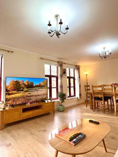 a living room with a large flat screen tv at Flat in Manchester, Ardwick in Manchester