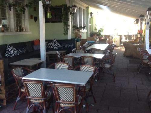a group of tables and chairs in a restaurant at Hotel Restaurant Anna in Ramstein-Miesenbach