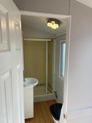 a bathroom with a sink and a bath tub at La Mare Resort in Gothenburg